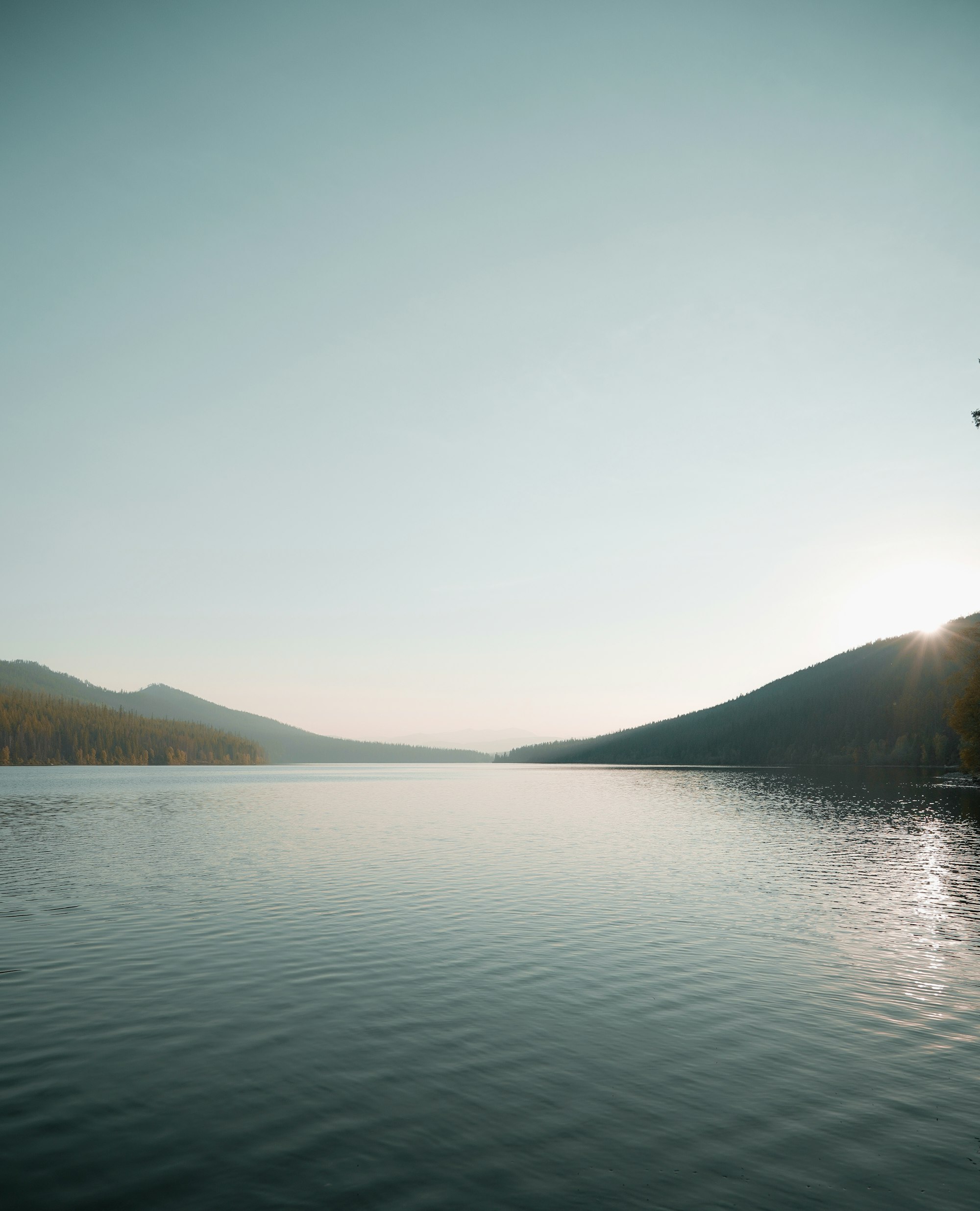 Calm lake beneath gentle mountains